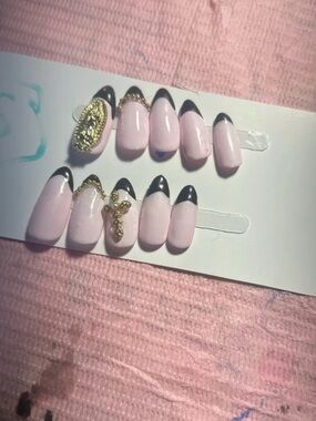 Soft Pink Press-On Nails with Black Tips and Gold Charms